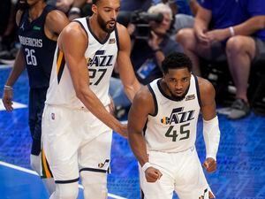 Utah Jazz's Rudy Gobert (27) and Donovan Mitchell (45) celebrate a basket by Mitchell in the second half of Game 1 of an NBA basketball first-round playoff series against the Dallas Mavericks, Saturday, April 16, 2022, in Dallas. (AP Photo/Tony Gutierrez)