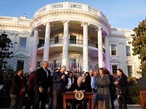 (Patrick Semansky | AP) President Joe Biden signs the Respect for Marriage Act on Tuesday, Dec. 13, 2022, on the South Lawn of the White House in Washington.