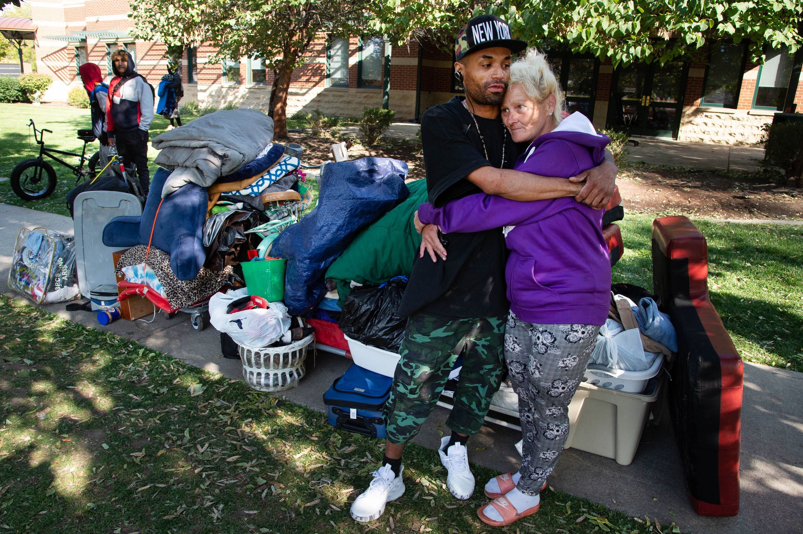 (Francisco Kjolseth  |  The Salt Lake Tribune) Raymond Wilkerson and Jonnie Vierra embrace at the Salt Lake County Health Department, backed by police, forces a clean up of homeless camps set up near Taufer Park in Salt Lake City on Thursday, Sept. 10, 2020, while homeless advocates confronted the police abhorring their actions.