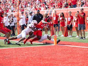 (University of Utah Athletics) Utah running back Chris Curry scores a touchdown while being tackled by two Souther Utah defenders during the game on Saturday, Sept. 10, 2022, at Rice-Eccles Stadium.