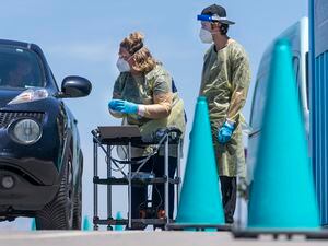 (Leah Hogsten | The Salt Lake Tribune) A registered nurse and a clinical assistant get nasal swabs and information from a family of four at the Nomi Health COVID-19 testing site in the parking lot of Amazon on Friday, June 10, 2022 in Salt Lake City.