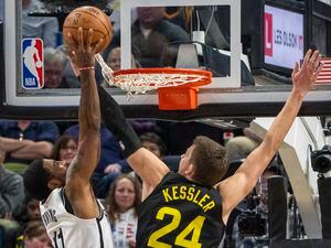 (Rick Egan | The Salt Lake Tribune) Brooklyn Nets guard Kyrie Irving (11) goes in for a dunk, as Utah Jazz center Walker Kessler (24) gets tangled up in the net, in NBA action between the Utah Jazz and the Brooklyn Nets at Vivint Arena, on Friday, Jan. 20, 2023.