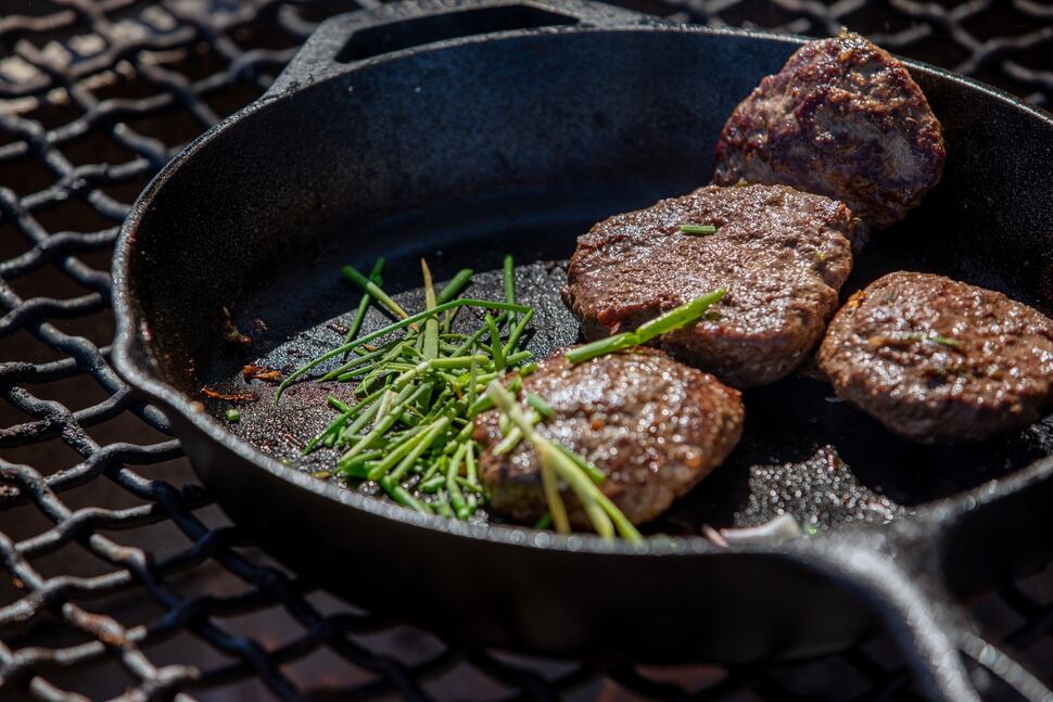 Thosh Collins prepares venison burgers with i’itoi onions on the Salt River Pima-Maricopa Indian Community, a few miles from their home outside Scottsdale, Ariz., on April 5, 2020. Collins and his wife, Chelsey Luger, founded an Indigenous wellness program called Well for Culture. (Caitlin O'Hara/The New York Times)