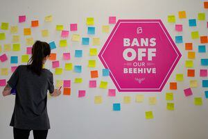 (Francisco Kjolseth | The Salt Lake Tribune) People add their thoughts to a wall of a new art exhibit entitled Bans Off Our Beehive, hosted by Planned Parenthood Association of Utah showcasing artwork created by people about their abortions at Medium Studio in Sugarhouse on Friday, May 13, 2022. The Utah Attorney General's office has asked the state Supreme Court for permission to appeal the current hold on Utah's trigger law.