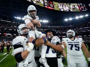 (Ashley Landis | AP) Utah State quarterback Cooper Legas (5) is hoisted on the shoulders of his teammates after they won the LA Bowl 24-13 over Oregon State in Inglewood, Calif., Saturday.
