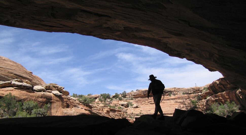 (Al Hartmann | The Salt Lake Tribune) A hiker explores an alcove in a sandstone canyon in the Cedar Mesa area in San Juan County. The mesa is loaded with Anasazi Indian sites. Cedar Mesa is on the Southern Utah Wilderness Alliance list of Utah's ten most threatened wilderness treasures.