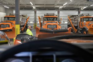 (Chris Samuels | The Salt Lake Tribune) Jake Brown walks by snowplows at a UDOT facility in Cottonwood Heights, Thursday, Dec. 2, 2021. A labor shortage could affect the number of snowplows that can be on the road this winter. Brown says 60% of the facility's workers have turned over in the past year.