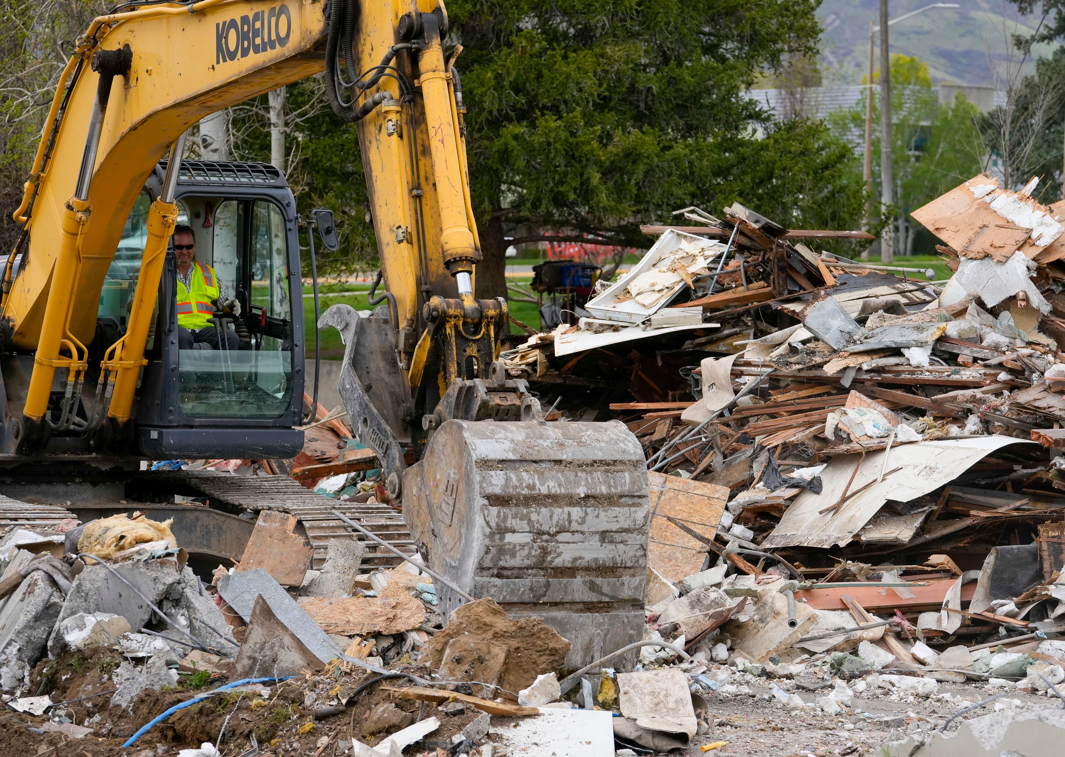 (Bethany Baker | The Salt Lake Tribune) Crews load debris from the demolished Sizzler restaurant into trailers in Salt Lake City on Wednesday, April 17, 2024.