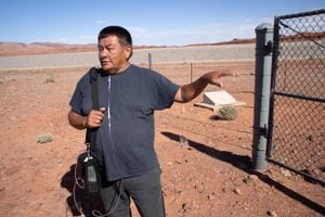 (Chip Thomas) Moren Binale stands outside the Mexican Hat superfund site May 31, 2022, where he worked on uranium remediation efforts in the 1990s that likely contributed to a chronic lung condition.