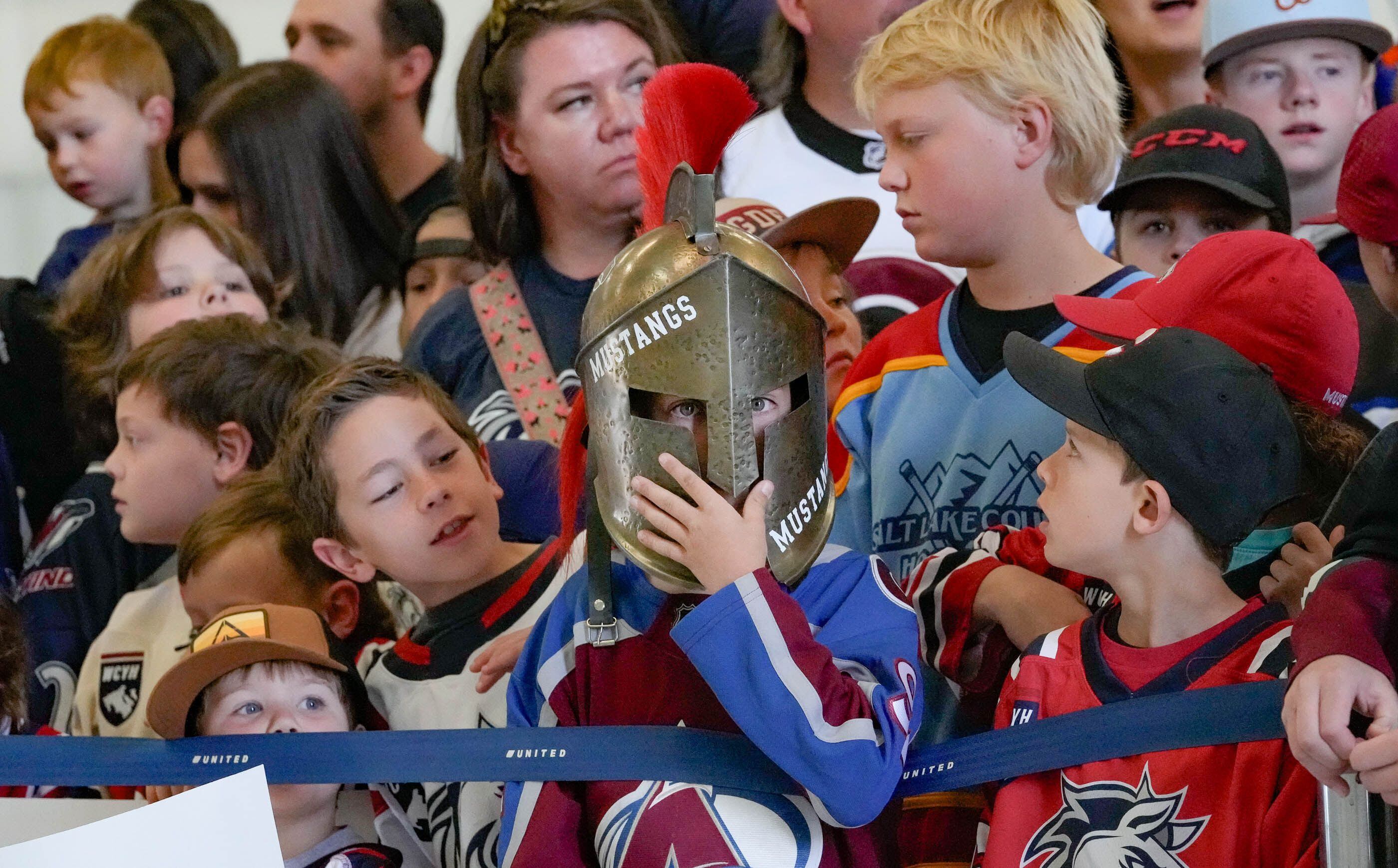 (Francisco Kjolseth  |  The Salt Lake Tribune) Beau Williams, 10, wears a Mustang's helmet as he joins other young hockey fans gathered at the airport for the arrival of the new NHL team on Wednesday, April 24, 2024.