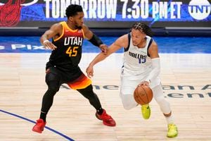 (Tony Gutierrez | AP) Utah Jazz guard Donovan Mitchell (45) defends as Dallas Mavericks guard Jalen Brunson (13) works to the basket in the second half of Game 2 of an NBA basketball first-round playoff series, Monday, April 18, 2022, in Dallas.