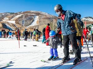 (Rick Egan | The Salt Lake Tribune) Zac Beveridge skis with 3-year-old Finley on opening day at Park City, on Friday, Nov. 20, 2020.