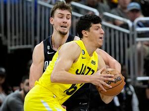 Utah Jazz's Simone Fontecchio, right, makes a move to get around Orlando Magic's Franz Wagner, left, during the first half of an NBA basketball game, Thursday, March 9, 2023, in Orlando, Fla. (AP Photo/John Raoux)