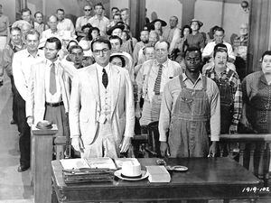 (Universal Studios Home Entertainment | AP) This picture provided by Universal Studios Home Entertainment shows actors Gregory Peck, foreground left, and Brock Peters, foreground right, in a scene from the 1962 film "To Kill a Mockingbird."