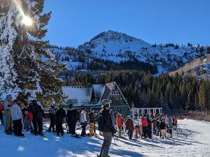 (Julie Jag | The Salt Lake Tribune) Snowboarders and skiers line up to ride the Majestic lift at Brighton Resort on Monday, Nov. 22, 2021. Brighton will be one of at least seven ski and snowboard areas on the Ikon Pass that will require reservations for the 2022-23 season.