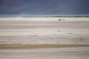 (Trent Nelson  |  The Salt Lake Tribune) Hikers at the Great Salt Lake on Saturday, June 18, 2022. Utah Sen. Mitt Romney told reporters on Wednesday, July 20, 2022, that it would likely take billions of dollars to save Great Salt Lake.