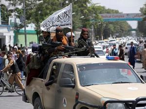 (Rahmat Gul | AP) Taliban fighters display their flag as they patrol in Kabul, Afghanistan, Thursday, Aug. 19, 2021. The U.S. Commission on International Religious Freedom accuses the Taliban-led regime of routinely violating religious freedoms of minority faiths.