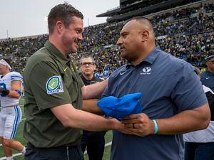 (Andy Nelson | AP) Oregon head coach Dan Lanning, left, and BYU head coach Kalani Sitake meet after an NCAA college football game Saturday, Sept. 17, 2022, in Eugene, Ore.