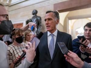 (J. Scott Applewhite | AP) Sen. Mitt Romney, R-Utah, is surrounded by reporters at the Capitol in Washington, Wednesday, Nov. 16, 2022. Romney voted to advance a bill in the U.S. Senate, that if passed, would codify same-sex marriage nationwide.