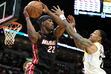 Miami Heat forward Jimmy Butler (22) looks to pass as Utah Jazz forward John Collins (20) defends during the first half of an NBA basketball game, Saturday, March 2, 2024, in Miami. (AP Photo/Lynne Sladky)