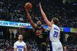 Cleveland Cavaliers guard Donovan Mitchell (45) shoots between Orlando Magic guard Cole Anthony (50) and center Moritz Wagner (21) in the first half of Game 7 of an NBA basketball first-round playoff series Sunday, May 5, 2024, in Cleveland. (AP Photo/Sue Ogrocki)
