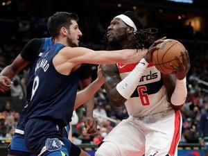 Washington Wizards' Montrezl Harrell (6) is defended by Minnesota Timberwolves' Leandro Bolmaro, left, during the first half of an NBA basketball game Wednesday, Dec. 1, 2021, in Washington. (AP Photo/Luis M. Alvarez)