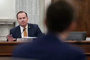 (Ken Cedeno | Pool via AP) Sen. Mike Lee, R-Utah, photographed in January, is scolding Delta Air Lines and Coca-Cola for criticizing Georgia’s new election law as voter suppression.