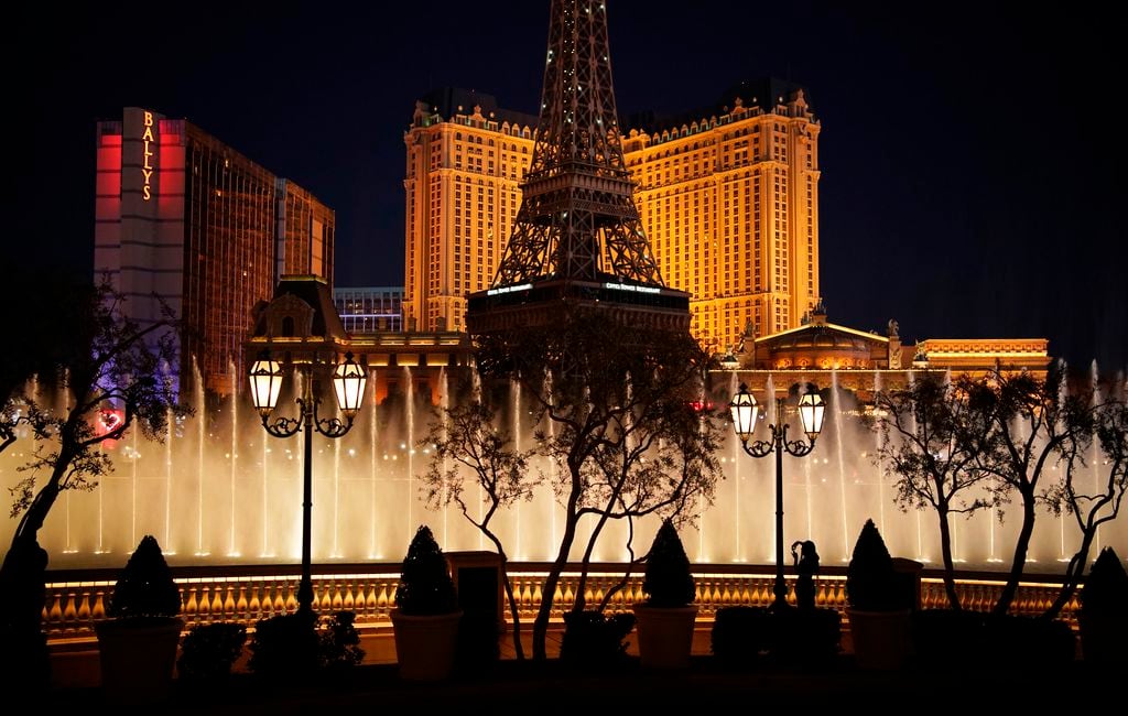 (John Locher | Associated Press) A woman watches the fountains at the Bellagio hotel-casino along the Las Vegas Strip.