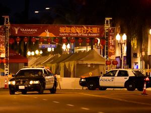 (Jae C. Hong | AP Photo) Two police vehicles are seen near a building where a shooting occurred in Monterey Park, Calif., Sunday, Jan. 22, 2023. Nine people were killed in a mass shooting late Saturday in a city east of Los Angeles following a Lunar New Year celebration that attracted thousands, police said.