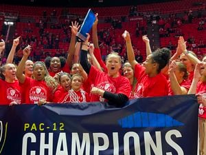 (Rick Egan | The Salt Lake Tribune) The Utes hold up the PAC-12 trophy, as they celebrate the Utes 84-78 win over the Stanford Cardinals, in PAC-12 action, at the Jon M. Huntsman Center, on Saturday, Feb. 25, 2023.