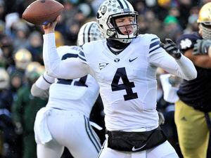 Brigham Young quarterback Taysom Hill throws a pass in the first half of an NCAA college football game Saturday, Nov. 23, 2013, in South Bend, Ind. (AP Photo/Joe Raymond) 