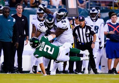 New York Jets' Zach Wilson falls during a play during the first half of a preseason NFL football game against the Philadelphia Eagles on Friday, Aug. 12, 2022, in Philadelphia. He was injured on the play. (AP Photo/Matt Rourke)