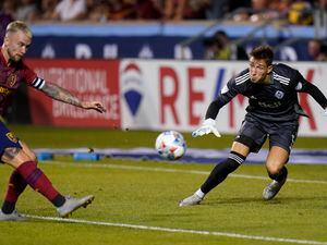 (Rick Bowmer | AP) Vancouver Whitecaps goalkeeper Thomas Hasal defends as Real Salt Lake midfielder Albert Rusnak strikes the ball during the second half of an MLS soccer match Wednesday, July 7, 2021, in Sandy.