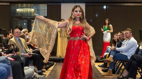 Refugees and immigrant women walk the runway at Women of the World Fashion Show