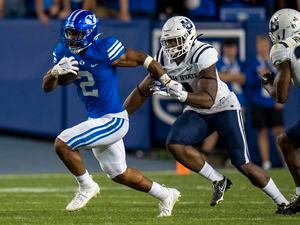(Rick Egan | The Salt Lake Tribune) Brigham Young running back Christopher Brooks (2) runs for the Cougars, in Football action between the Brigham Young Cougars and the Utah State Aggies, at LaVell Edwards Stadium in Provo, on Thursday, Sept. 29, 2022.