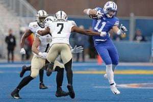 BYU defensive back Austin Lee (11) tries to get past Western Michigan linebacker Najee Clayton (7) during an interception return in the second half of the Famous Idaho Potato Bowl NCAA college football game, Friday, Dec. 21, 2018, in Boise, Idaho. (AP Photo/Steve Conner)