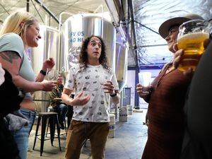 (Francisco Kjolseth | The Salt Lake Tribune) Brewer and podcaster David Jimenez, is joined by friends as they honor his contributions to the brewing community during a party at Kiitos Brewery in Salt Lake City on Friday, May 20, 2022. Jimenez is host and creator of The Taste Makers podcast.