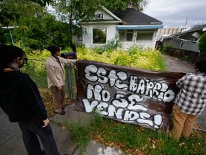 (Francisco Kjolseth | The Salt Lake Tribune) People put up a signs that reads “this neighborhood is not for sale!” in front of the home that Gaspar Valencia lived in for eight years before being forced out by a developer with plans to tear it down along with adjacent properties to build an apartment on the site. On Saturday, Aug. 6, 2022, the community gathered to protest the gentrification they see happening to their neighborhood. 