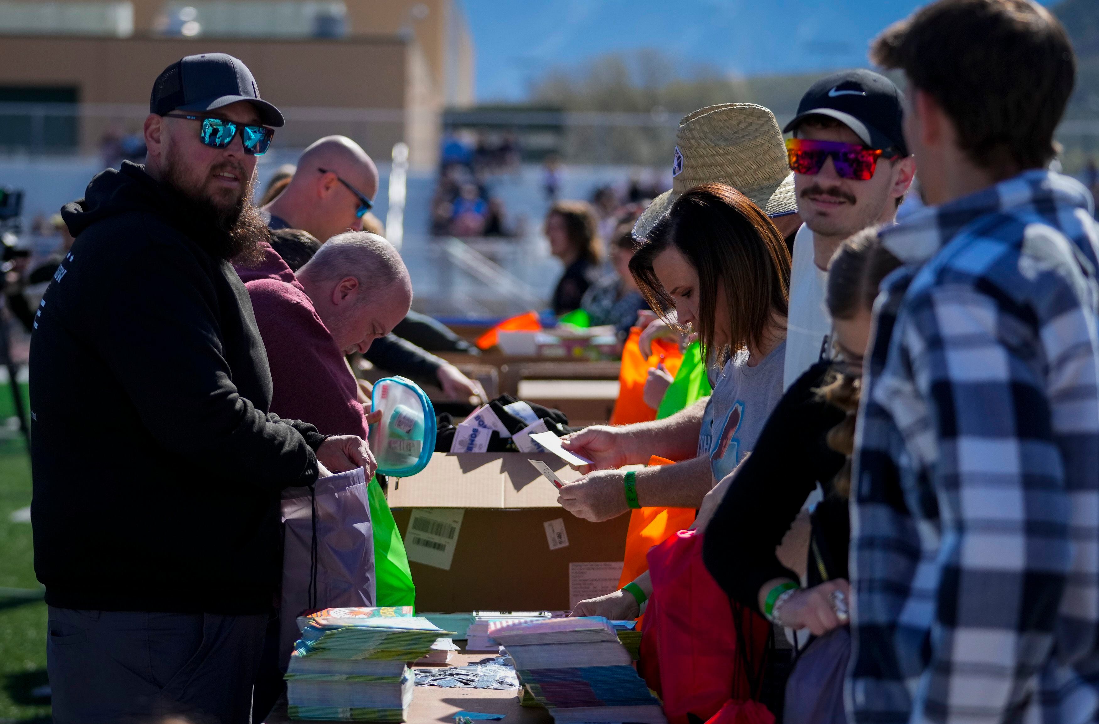 (Bethany Baker  |  The Salt Lake Tribune) Volunteers pack resource kits for Kevin BaconÕs nonprofit SixDegrees at a charity event to commemorate the 40th anniversary of the movie "Footloose" on the football field of Payson High School in Payson on Saturday, April 20, 2024.