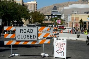 (Steve Griffin  |  The Salt Lake Tribune) Workers cement  fence posts into position on Rio Grande Street in Salt Lake City in September.