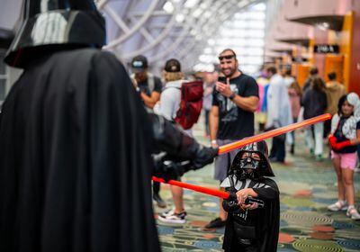 (Trent Nelson  |  The Salt Lake Tribune) A young Darth Vader (Weston Charleson) takes on his older self at FanX Salt Lake Comic Convention on Thursday, Sept. 22, 2022, in the Salt Palace Convention Center in Salt Lake City.