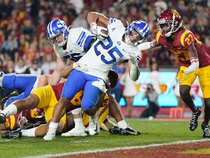 Brigham Young running back Tyler Allgeier (25) falls in to the end zone for a touchdown during the first half of an NCAA college football game against Southern California in Los Angeles, Saturday, Nov. 27, 2021. (AP Photo/Ashley Landis)