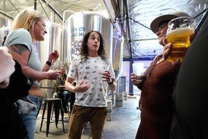 (Francisco Kjolseth | The Salt Lake Tribune) Brewer and podcaster David Jimenez, is joined by friends as they honor his contributions to the brewing community during a party at Kiitos Brewery in Salt Lake City on Friday, May 20, 2022. Jimenez is host and creator of The Taste Makers podcast.
