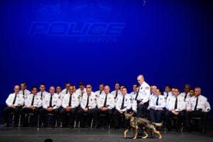 (Trent Nelson  |  The Salt Lake Tribune)  Riverton police Officer and K-9 handler Spencer Hiatt introduces Titan, a police dog, during introductions of the thirty-five officers that make up the city's new police department during a swearing-in ceremony at Riverton High School on Tuesday June 25, 2019.