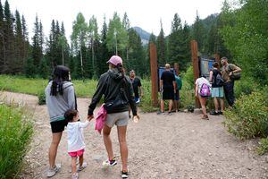 (Francisco Kjolseth | The Salt Lake Tribune) Families begin their hike to Donut Falls in Big Cottonwood Canyon on Thursday, Aug. 4, 2022. The Forest Service is floating the possibility of enacting fees at trailheads, while reducing fees for some picnic areas. Fees could be at different places around the Uintah-Wasatch-Cache National Forest.