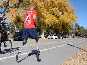 Al Hartmann  |  The Salt Lake Tribune) 	Rob Jones, a retired Marine Corps Sergeant who lost both legs when he stepped on an improvised explosive device in Afghanistan, runs a marathon, (26.2) miles in Liberty Park in Salt Lake City Wednesday Oct. 25. He won a Bronze Medal in the Paralympics and he wis the first and only double above the knee amputee to ride a normal bicycle 5,180 miles across America. Now, he is set to run 31 marathons in 31 days in 31 major cities. Starting in London on October 12th, and continuing in the United States and Toronto, he will run 26.2 miles in the selected city on his own, travel to the next city, and repeat, ending appropriately on Veterans Day in our Nation’s Capital.  His motto, “Survive. Recover. Live.” 
