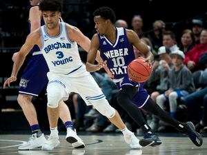 (Rick Egan  |  The Salt Lake Tribune)  Brigham Young Cougars guard Elijah Bryant (3) tries to keep up withWeber State Wildcats guard Jerrick Harding (10), in Beehive Classic basketball action at the Vivint SmartHome Arena, Saturday, December 9, 2017.