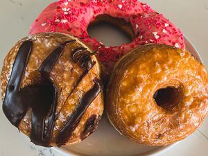 (Aimee L. Cook) A Texas-sized doughnut, top, and layered cronuts are among the specialties at Donut Star Café in Draper.