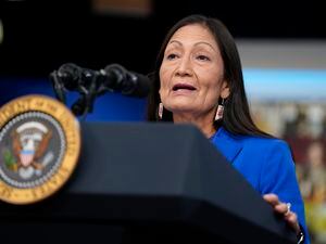 (Evan Vucci | AP Photo)  Interior Secretary Deb Haaland speaks during a Tribal Nations Summit during Native American Heritage Month, in the South Court Auditorium on the White House campus, on Nov. 15, 2021, in Washington. An initial investigation commissioned by Haaland cataloged some of the brutal conditions that Native American children endured at more than 400 boarding schools that the federal government forced them to attend between 1819 and 1969.