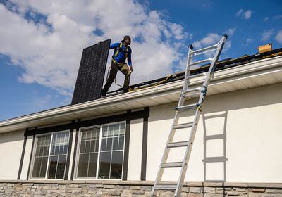 (Trent Nelson  |  The Salt Lake Tribune) LJ Jenkins, with Elan Solar, installs solar panels on a Santaquin home on Friday, Nov. 6, 2020.